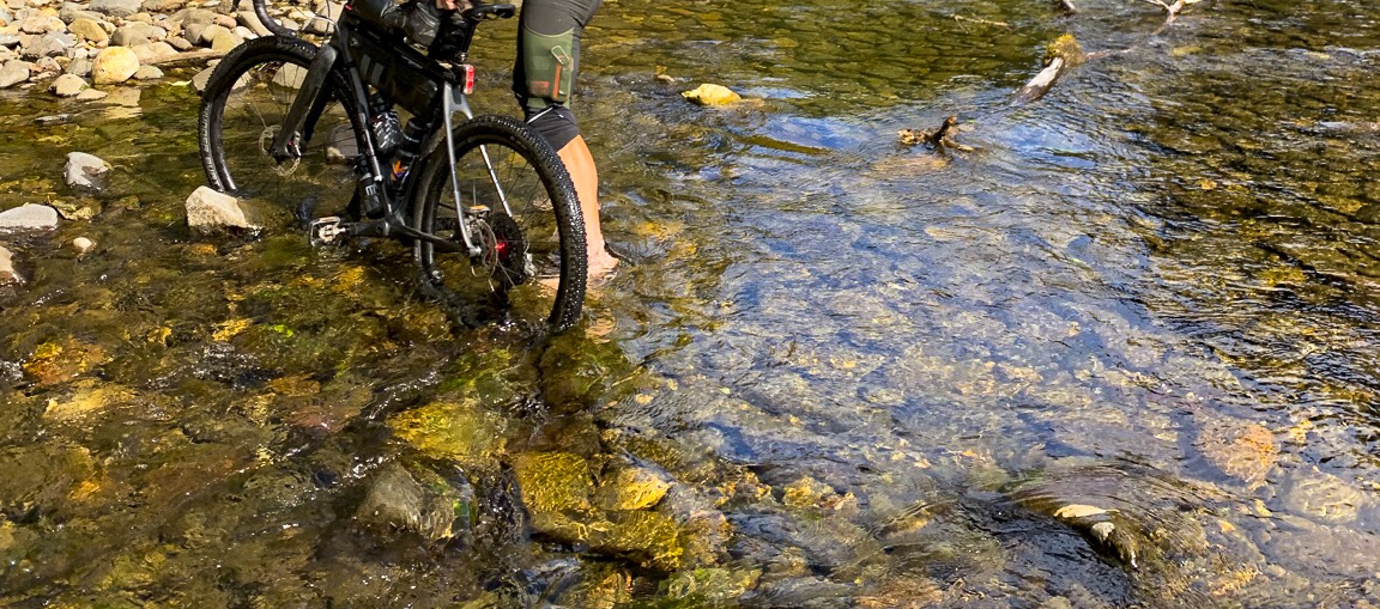 wading across a stream with my bicycle